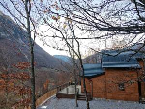 a house with a balcony and a view of the mountains at Boga Chalet in Bogë