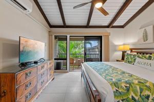 a bedroom with a large bed and a television at Wailea Ekolu 1604 · WE 1604 Wailea 2BD Condo w AC Pool Near Beac in Kihei