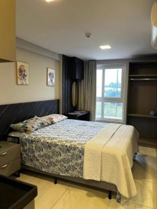 a bedroom with a bed and a window at Flat 201 Paradise in João Pessoa