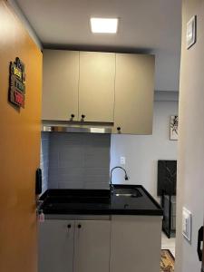 eine Küche mit weißen Schränken und einer Spüle in der Unterkunft Flat 201 Paradise in João Pessoa + 11 Fotos