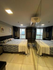 a bedroom with two beds and a basketball hoop at Flat 201 Paradise in João Pessoa