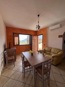 a living room with a table and a couch at Villa Su Navru in Irgoli