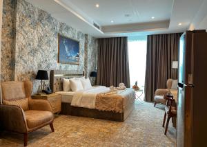 ドーハにあるAl Mansour Plaza Hotelのベッドと椅子のあるホテルの部屋 +45枚の写真