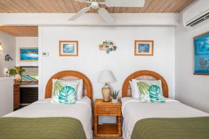 two beds sitting next to each other in a room at Napili Point C22 · NP C22 Oceanfront Views from 2BD West Maui Co in Lahaina +51 photos