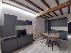 a kitchen and dining room with a table and chairs at Borgo delle Colonne 22 in Parma