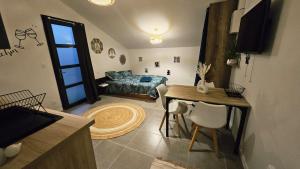 a living room with a table and a couch at Studio cosy au calme , Boé in Boé