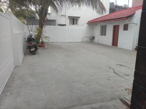 a parking lot with a motorcycle parked next to a building at SHREVIK Comforts in Chikmagalūr