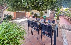 a table and chairs sitting on a patio at 2 Bedroom Beautiful Home In Benalmadena in Benalmadena Costa