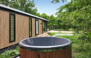a large tub sitting outside of a house at 3 Bedroom Pet Friendly Home In Oud Gastel in Zegge +10 photos