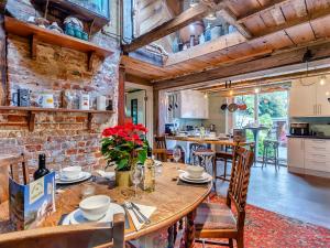 a kitchen and dining room with a table and chairs at Hook & Hatchet - Uk48201 in Bicknor