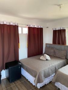 a bedroom with a bed with two pillows on it at Pousada Ap in Acaraú +15 photos