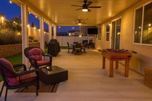 a screened porch with a pool table and chairs at Windridge Manor - Wine Country Retreat with 6 Beds, Garden, Pool, Games & BBQ in Winchester