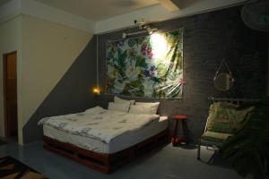 a bedroom with a bed with a painting on the wall at Bụi Homestay - Ferry to Rạch Giá in Rạch Giá +83 photos