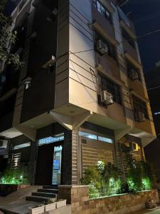 a tall building with an umbrella in front of it at Karachi Inn PECHS in Karachi