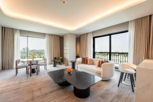 a living room with a couch and a table at MOVENPICK HOTEL AL ZAYTOON BAGHDAD in Baghdad