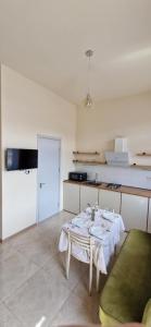a kitchen with a table with a white tablecloth on it at Guest house marissi in Surami