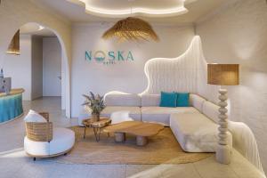 a living room with a couch and a table at Noska Hotel in Phu Quoc +78 photos