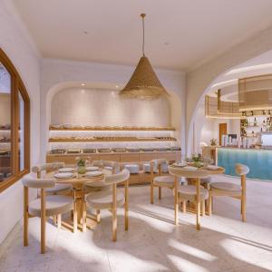 a dining room with tables and chairs and a pool at Noska Hotel in Phu Quoc