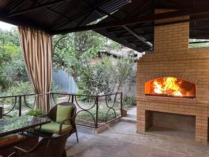 a fireplace on a patio with a chair and a table at Apartment in Yerevan in Yerevan