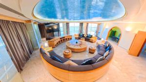 an image of a living room with a large couch at Oryx Grand Hotel Jebel Hafeet in Al Ain