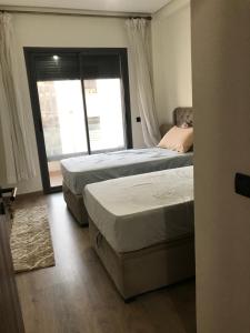 Ένα ή περισσότερα κρεβάτια σε δωμάτιο στο appartement