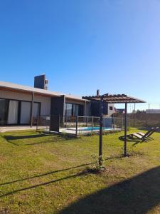 a batting cage in a field in front of a building at Belize Apart in San José