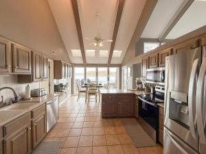 a kitchen with stainless steel appliances and a table at Lakefront Home 5BD3BA DockGrillsDeckKayaks-16 in Sunrise Beach