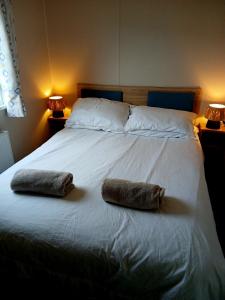 a bed with two pillows on top of it at Caravan-Blackpool-FamilyFriendly-Activities in Fleetwood +42 photos