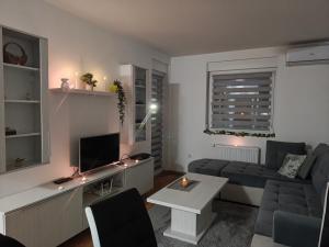 a living room with a couch and a table at Urban escape in Doboj