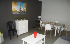 a living room with a table and a dining room at Casa Baïla in Rochefort