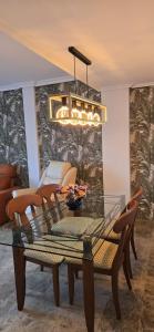 a dining room with a glass table and chairs at Apartamento Cozy Inns Playa in Torremolinos