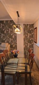 a dining room with a glass table and chairs at Apartamento Cozy Inns Playa in Torremolinos +35 photos
