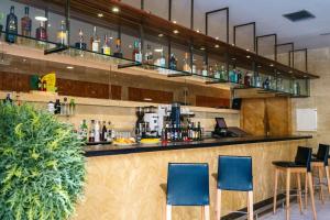 a bar in a restaurant with blue chairs at Abba Fonseca in Salamanca