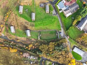 an aerial view of a farm with trees and trucks at Bothy 2 - Uk50472 in Greenhaugh +8 photos