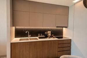 a kitchen with a sink and a counter at MOVENPICK HOTEL AL ZAYTOON BAGHDAD in Baghdad +92 photos