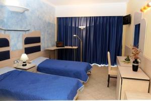 Postel nebo postele na pokoji v ubytování Hotel Kalithea