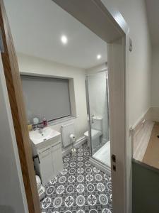 a bathroom with a toilet and a sink and a shower at Cosy Corner Cheadle in Cheadle +9 photos