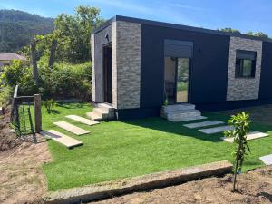 a small house with a yard with grass at Casinha do codecal in Labruja