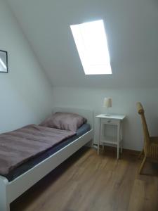 a bedroom with a bed and a table and a window at Monteurwohnung in ruhiger Lage in Spechtholzhock +10 photos