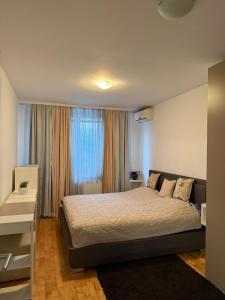 En eller flere senge i et værelse på Ilidža Central 74 Residence