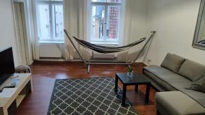a living room with a hammock and a couch at Stylish 2BR in Old Town Gem in Riga