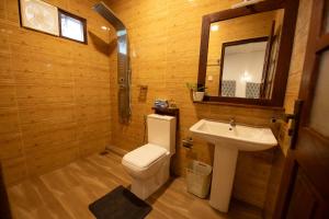 a bathroom with a white toilet and a sink at Zircon Ella in Ella +42 photos