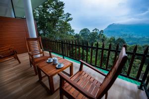 a balcony with two benches and a view of a mountain at Zircon Ella in Ella
