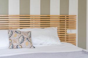 科莫Como Lake Chic Retreat的房间里有一张铺着白色床单和枕头的床