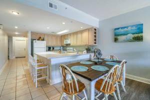 a kitchen with a table and chairs in a kitchen at Sandpiper #108 in Tybee Island