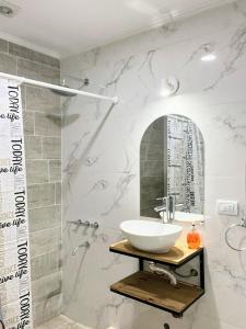 a bathroom with a sink and a mirror at Village De Las Sierras in Sierra de la Ventana +10 photos