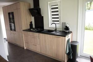 a kitchen with a sink and a counter top at Chalet La Diga in Mariënberg