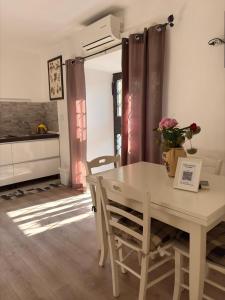 a kitchen and dining room with a table and chairs at Marilyn's House 2 in Frascati
