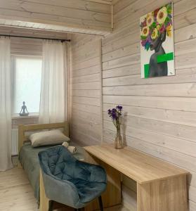 a bedroom with a bed and a desk and a table at Еко апартаменти DOM Art in Ovruch