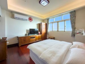 Ένα ή περισσότερα κρεβάτια σε δωμάτιο στο Yau Xian Bed and Breakfast